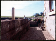 Wall with post awaiting last sleeper joint.